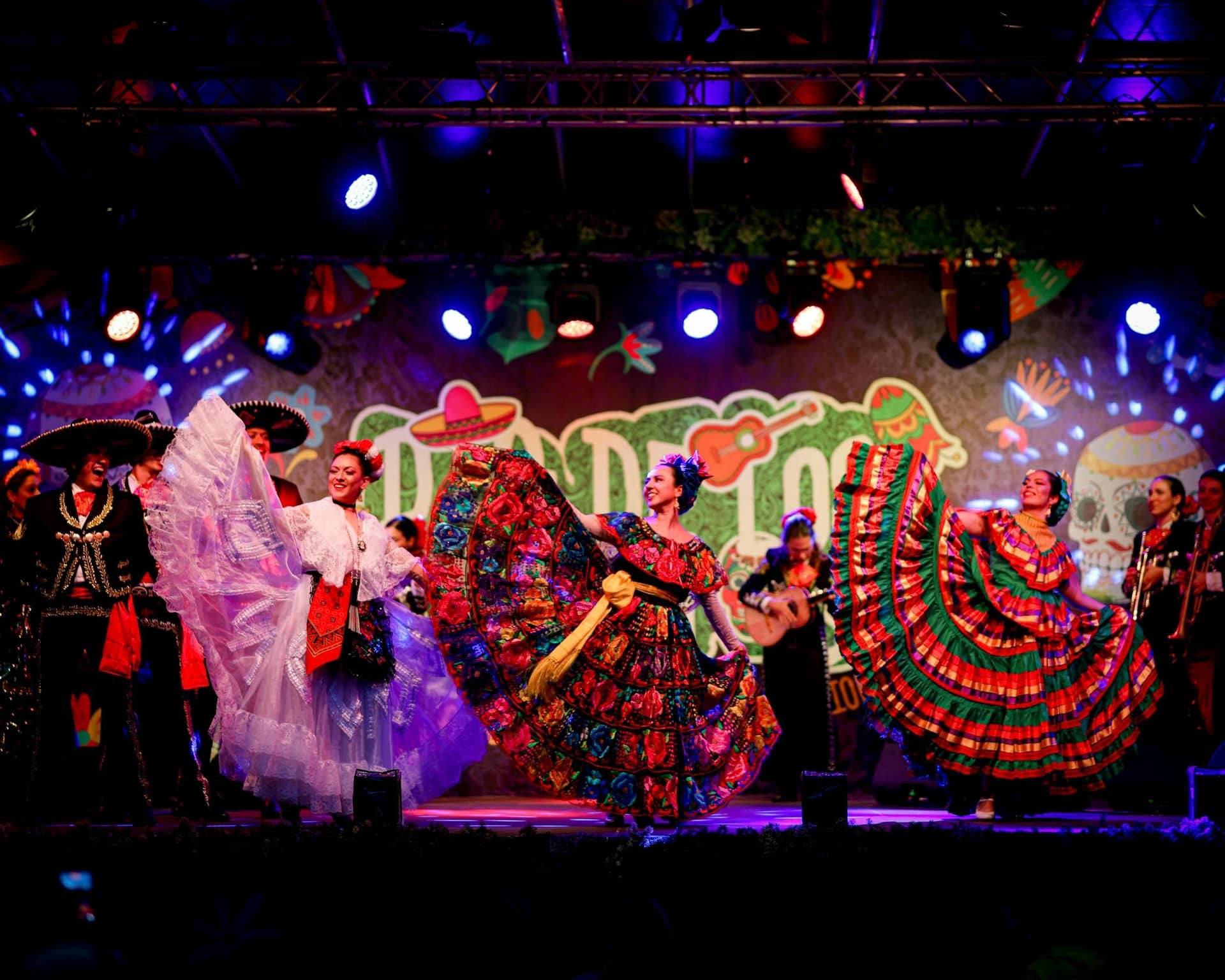 Dancers in Mexican dresses whirling on stage during Dia de los Muertos at the Jardin d'Acclimatation