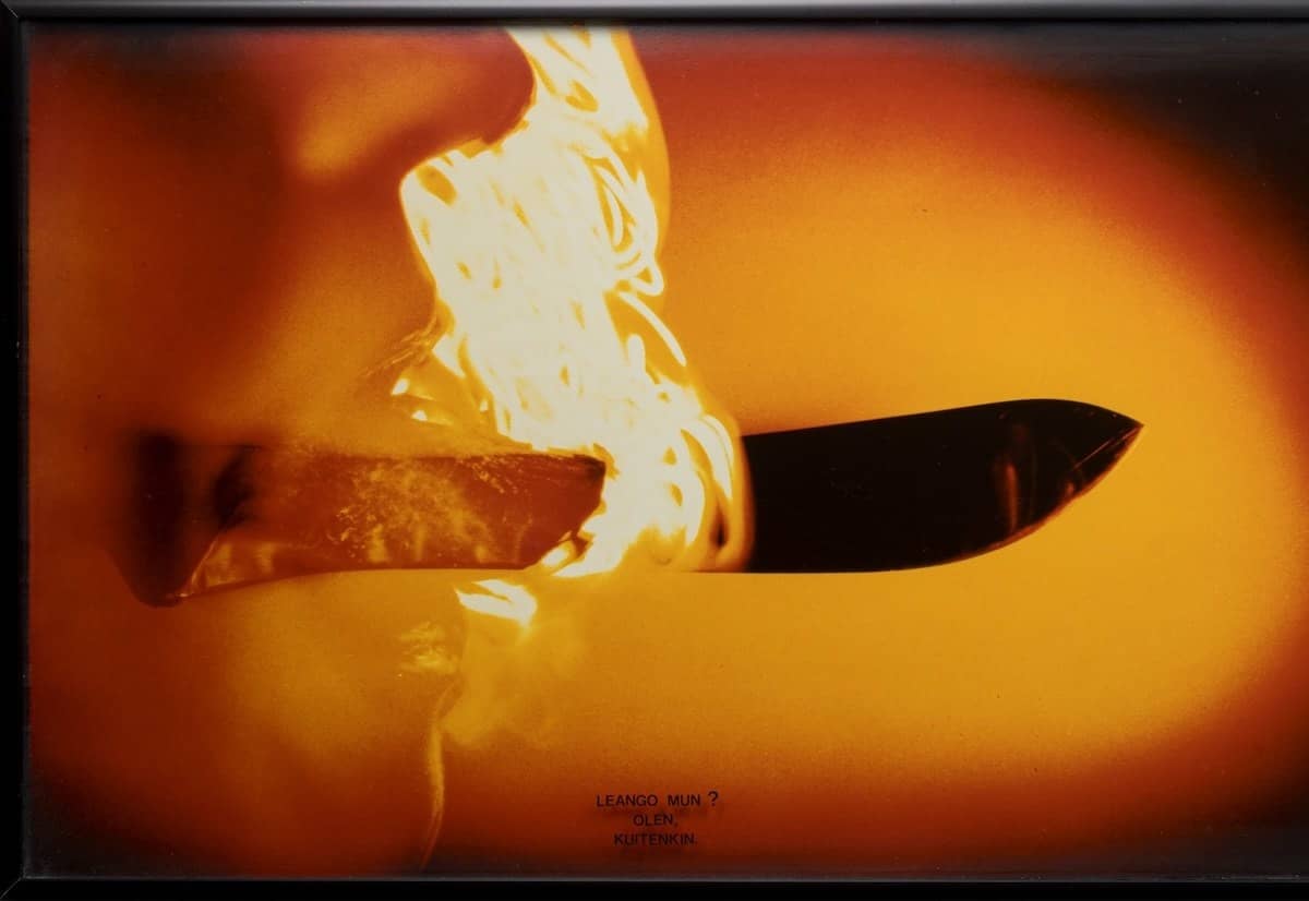 Détail de Sukupolvet II de Marja Helander : une lame de couteau sámi traversée par des flammes orangées
